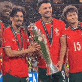 a group of soccer players holding a trophy with the number 15 on their shirt