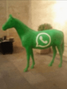a green horse with a whatsapp symbol painted on it