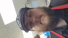 a man with a beard wears a hat that says bud light on it