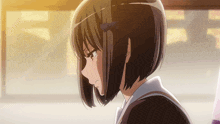 a girl with short hair and a bow in her hair looks sad