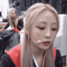 a close up of a woman with blonde hair making a funny face with her mouth open .