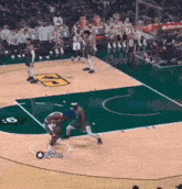a basketball game is being played on a court with the number 6 on the floor
