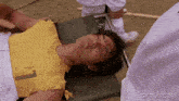 a man is laying on a stretcher with a gifrun.com watermark