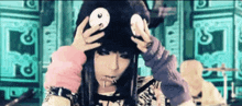 a girl wearing a black hat with a white circle on it