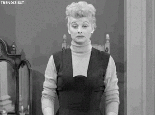 black and white gif of Lucille Ball taken from a clip of I Love Lucy. she shrugging her shoulders and putting her hands up as if to say "i don't know, what can you do?"