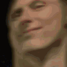 a close up of a person 's face with a black background