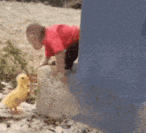 a baby is sitting on a concrete block with a yellow object in his mouth .
