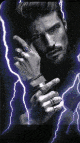 a man with rings on his fingers is standing in front of lightning