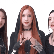 a woman with red hair is wearing a choker and a black hood
