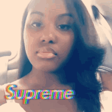 a woman in a car with supreme written on her chest