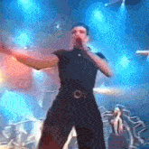 a man is singing into a microphone on a stage