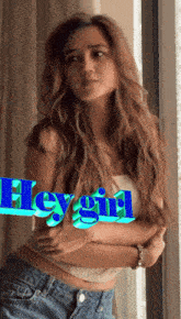 a woman standing in front of a window with the word hey girl written on the bottom