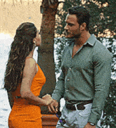a man and a woman are standing next to each other and talking