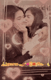 a girl kissing another girl on the cheek in front of a frame that says selfie_black