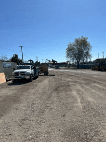 a dodge truck is parked in a dirt lot