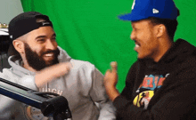 a man with a beard wearing a hoodie that says ' which ' on it