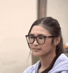 a woman wearing glasses is making a funny face and asking ano yun beh ?