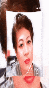 a picture of a woman 's face with the word love on the bottom