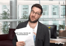 a man with a beard is holding a piece of paper that says super easy barely an inconvenience
