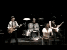 a man in a t-shirt that says ' i love you ' on it is dancing in front of a drum set