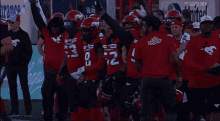 a group of football players wearing red jerseys with the number 9 on the front