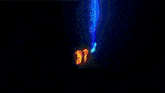 a blue background with a glowing orange object