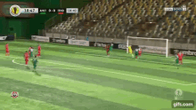 a soccer game is being played on a green field