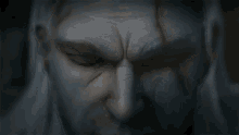 a close up of a man 's face with glowing orange eyes