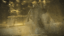 a statue of a man with a sword is standing in the middle of a desert