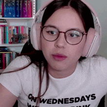 a girl wearing headphones and a white shirt that says on wednesdays