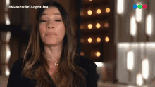 a woman with her eyes closed and the words masterchef argentina on the bottom right