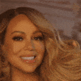 a close up of a woman 's face with long blonde hair
