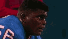 a man wearing a blue jersey with the number 5 on the back
