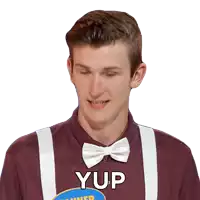 a man wearing a bow tie and suspenders has the word yup written on his shirt