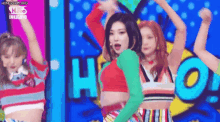 a group of women are dancing on a stage .