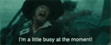 a man in a pirate hat is saying i 'm a little busy at the moment