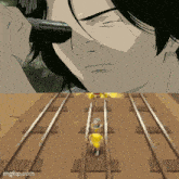 a man holding a gun next to a train track