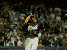 a baseball player wearing a giants jersey walks towards the dugout