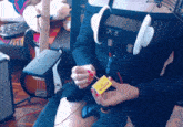 a woman wearing headphones is holding a box with a yellow label that says ' a ' on it