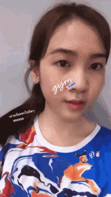 a woman has a sticker on her nose that says gym time