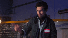 a man wears a name tag that says zeta