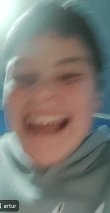 a blurry picture of a young boy with the name artur on the bottom right