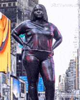 a statue of a woman stands in a city with pixverse.ai written on the bottom right