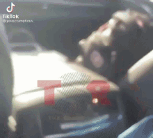 a person is sitting in the driver 's seat of a car