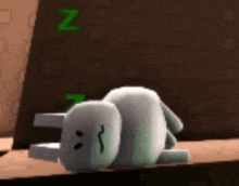 a cartoon character is laying on its back with the letter n above it