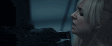 a blonde woman with a surprised look on her face is being held by a man