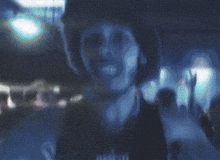 a blurry picture of a person with a few letters visible including a few letters that start with m