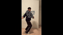 a man is kneeling down in front of a wall with a sign that says basic martial arts skills