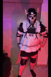 a person dressed in a maid outfit with a skull mask on their head