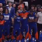 a group of basketball players wearing shirts that say win for the borough
